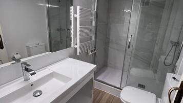 Shower, hair dryer, towels, toilet paper