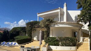 A white villa with a covered patio, outdoor seating, and a pool. - 3 bed Villa with Private Pool and Gardens- sleeps 6/8. 5min stroll to village.  (Olhos'de agua)
