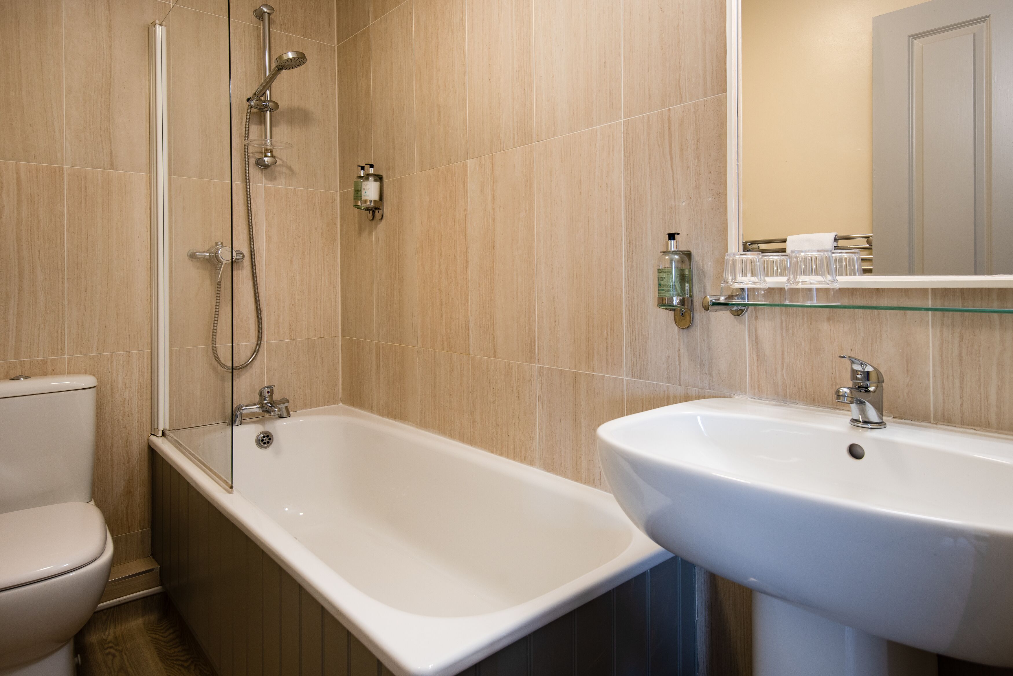 A bathroom with a bathtub, a toilet, and a sink.