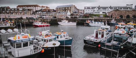 A marina with various boats docked, surrounded by buildings.