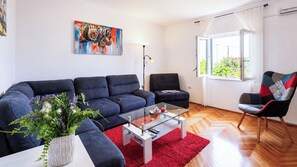 A modern living room with a sofa, armchair, and coffee table. - Mendy Sea View – 2 Bedrooms, 2 Baths near Split (Kaštel Sućurac)