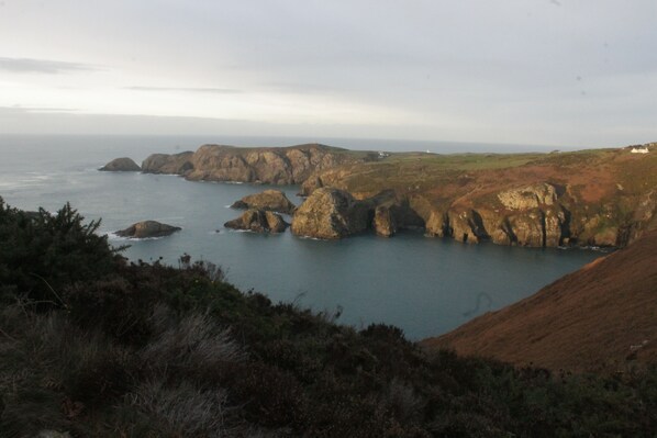A coastal landscape with rocky cliffs and a body of water.