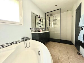 Bathtub, hair dryer, towels, soap