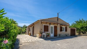 A two-story house with a tiled roof, a front porch, and potted plants. - Villa Roser Vell By SunVillas Mallorca (Pollença)