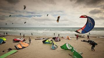 Enjoy kite surfing and windsurfing in this lively beach setting.