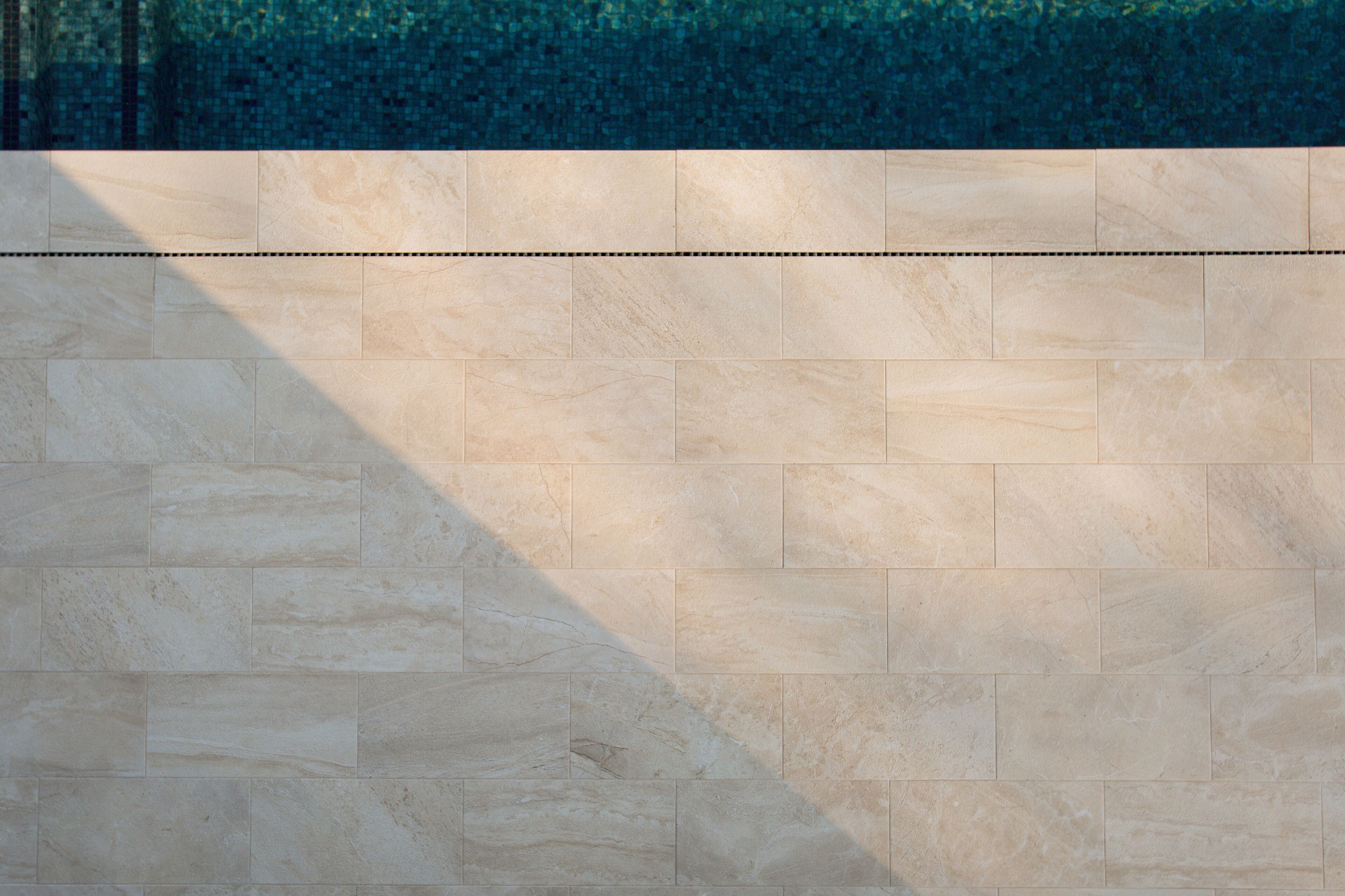 A tiled wall with a horizontal line running across it.