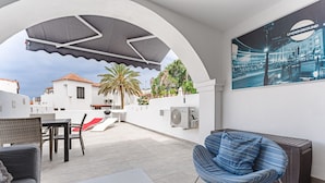 A rooftop patio with outdoor furniture, a grill, and a view of the cityscape. - Beautiful apartments  with large terrace close to the beach (Arona)