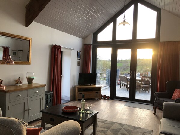 A spacious living room with a large TV, a wooden coffee table, and comfortable seating. - Self Catering Rural Cottage in Carmarthenshire (Peniel, Carmarthen)