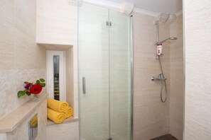 Shower, hair dryer, towels, toilet paper