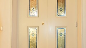 A white door with four glass panels featuring diamond-shaped patterns. - AMALFI COAST HOUSE DREAM VACATION (Conca dei Marini)