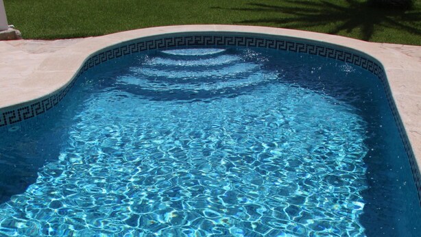 A rectangular swimming pool with clear blue water and a decorative edge. - Villa-Chalet with private pool, POOLSIDE BARBECUE (Manacor)