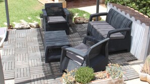 An outdoor patio with wicker furniture, a covered area, and potted plants. - Villa-Chalet with private pool, POOLSIDE BARBECUE (Manacor)