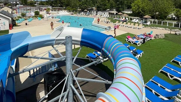 A water slide with a pool area, lounge chairs, and a clear sky. - Mobile home 6 sleeps 4 * Domaine in the heart of the Loire Valley Castles  (Veuzain-Sur-Loire)