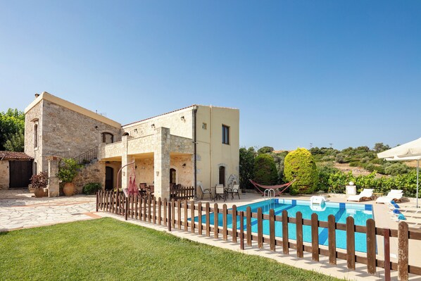 A heated pool, sun loungers