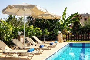 A heated pool, sun loungers