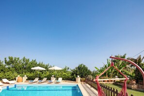 A heated pool, pool loungers