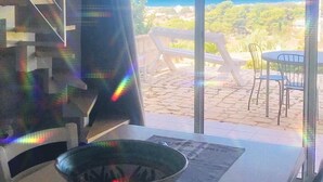 A room with a view of the ocean, a dining area with a table and chairs, and a staircase. - Single villa with private pool and lovely sea view (Cava D'aliga)