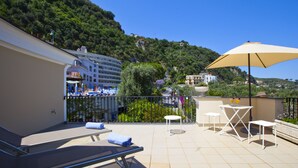 A rooftop terrace with lounge chairs, a table, and an umbrella. - Lovely 6 Bedrooms Villa With Pool, Located few Minutes From Sorrento Center (Sorrento)