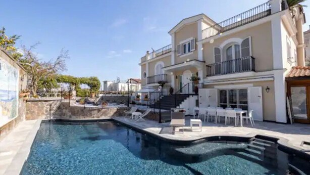 A swimming pool with a sun terrace, lounge chairs, and a staircase leading to a balcony. - Lovely 6 Bedrooms Villa With Pool, Located few Minutes From Sorrento Center (Sorrento)