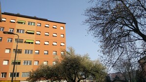 A multi-story building with balconies and windows.