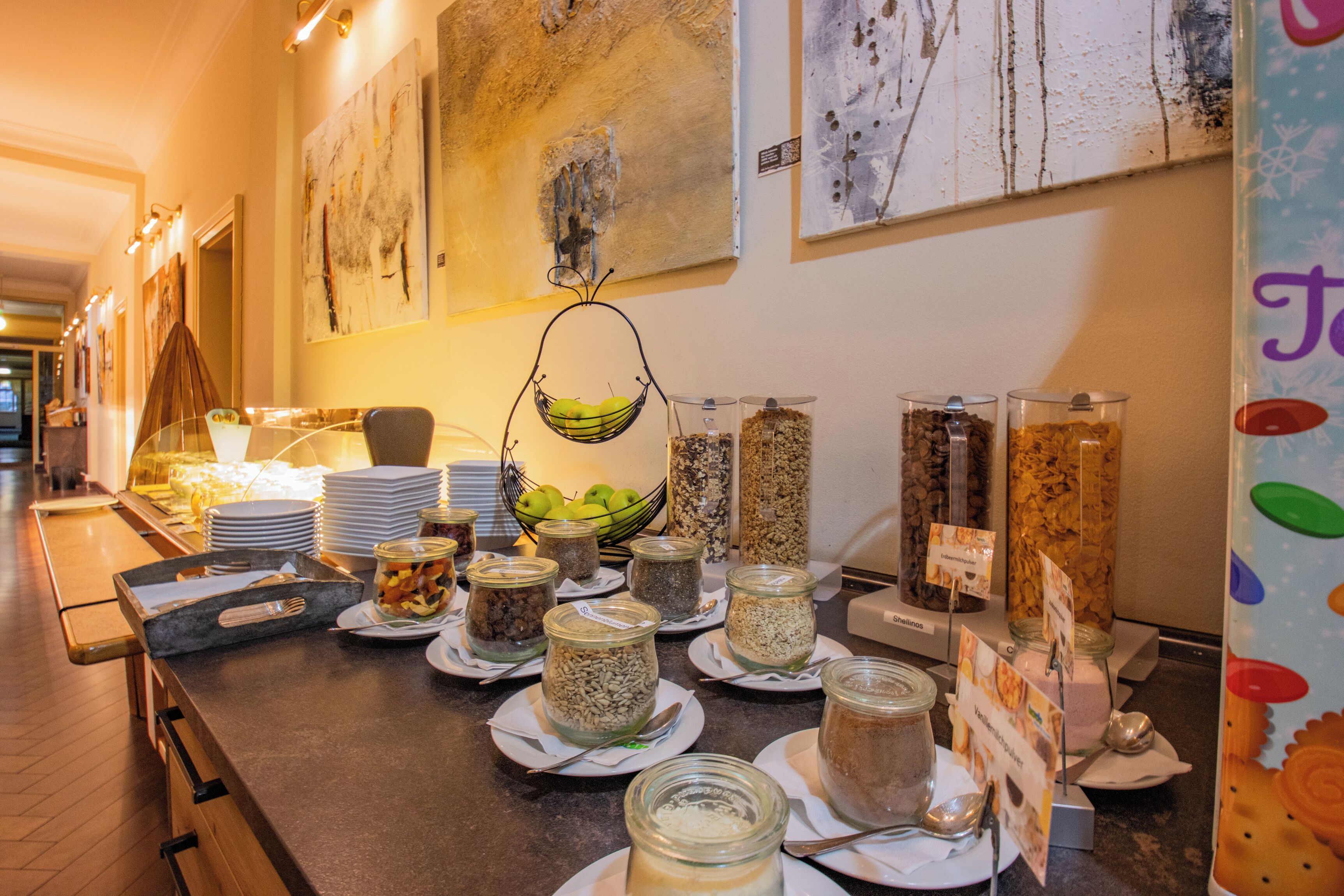 A buffet setup with various food items and condiments.