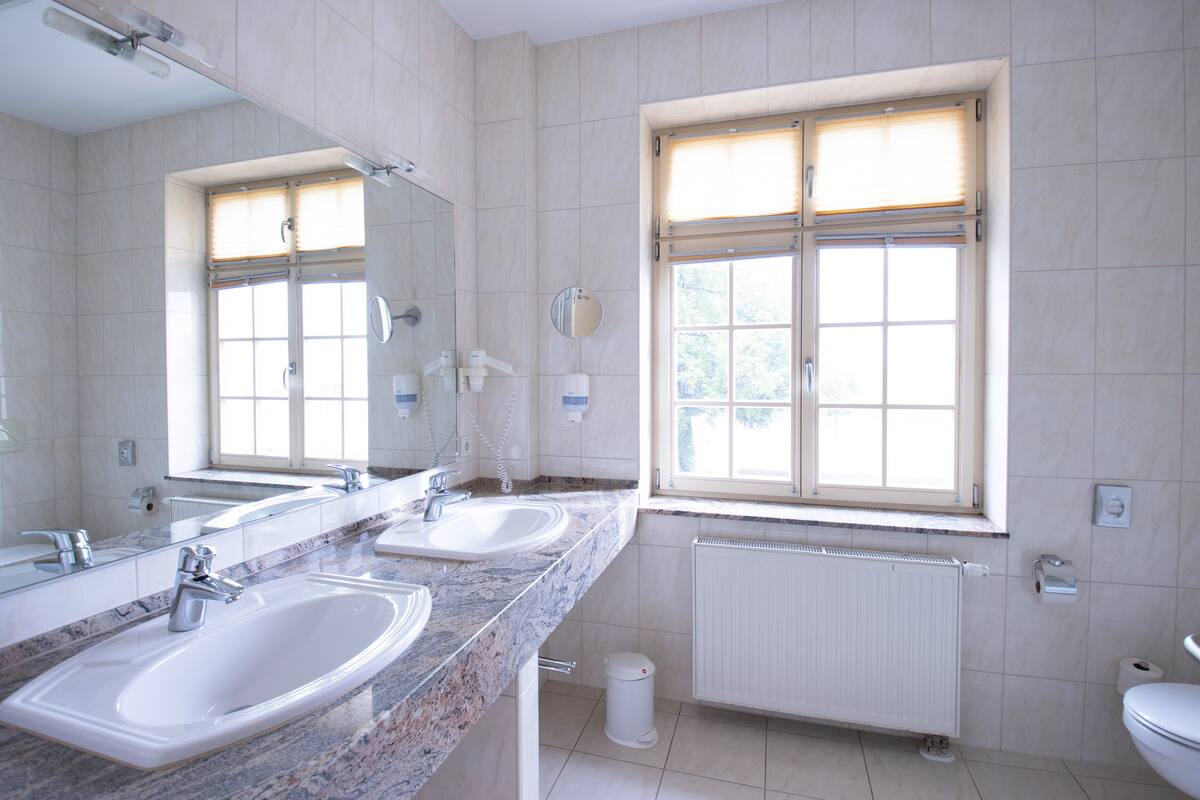 family room with connecting door in main building | bathroom | shower, free toiletries, hair dryer, towels