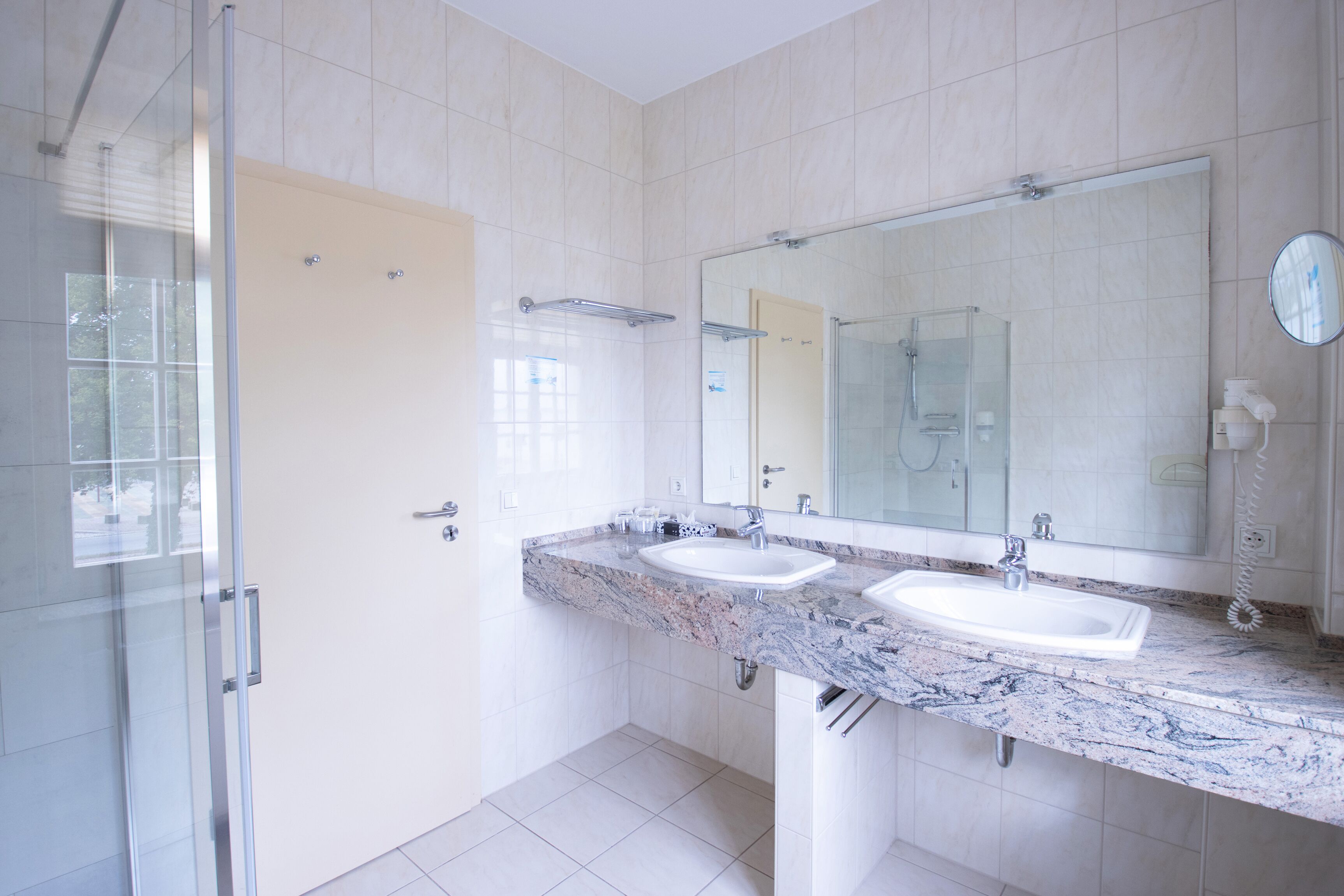 family room with connecting door in main building | bathroom | shower, free toiletries, hair dryer, towels