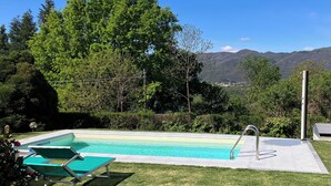 A swimming pool with a view of mountains in the background.