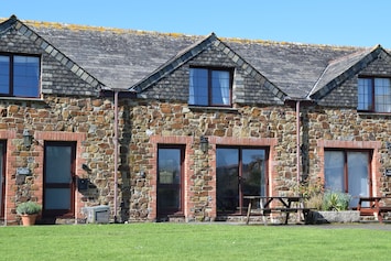 Front of cottage faces large lawned area