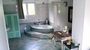 Bathtub, hair dryer, towels, toilet paper
