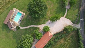 An aerial view of a property with a swimming pool, a covered patio, and a large tree. - Mansion - SONAC (Sonac)