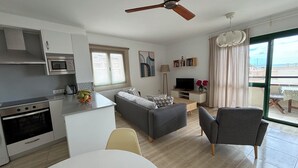 A modern apartment with a kitchen, dining area, living room, and balcony. - Buenavista, 2 bedrooms, Wifi, very sunny, terrace, sea views, central location (Morro Jable)