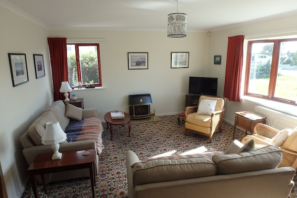 Sunny living room with smart tv and free wifi