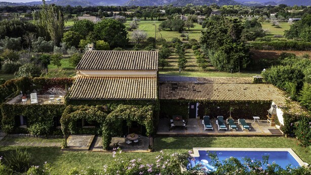 A villa with a tiled roof, a swimming pool, and a garden with outdoor seating. - Private Pool & Garden, BBQ, AC, PS4 and Views of the Tramuntana Mountains (Pollença)