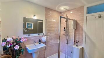 Bathtub, hair dryer, towels, toilet paper