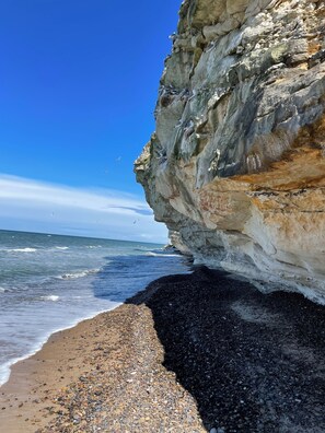 A rocky coastline with a clear sky.