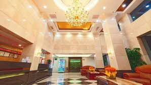 A spacious lobby with a large chandelier, a reception desk, and comfortable seating areas. - Dinghushan Hotel (Zhaoqing)