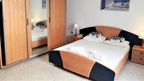 A bedroom with a bed, a wardrobe, a nightstand, and a lamp. - house / villa - SOUSSE (Sousse)