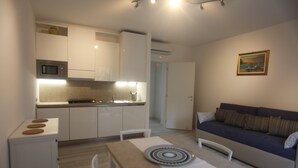 A compact living space with a kitchenette, a dining area, and a sofa. - BLUE DIAMOND in the 5Terre-Cod. Citra 011019-LT-0241 (Monterosso al Mare)