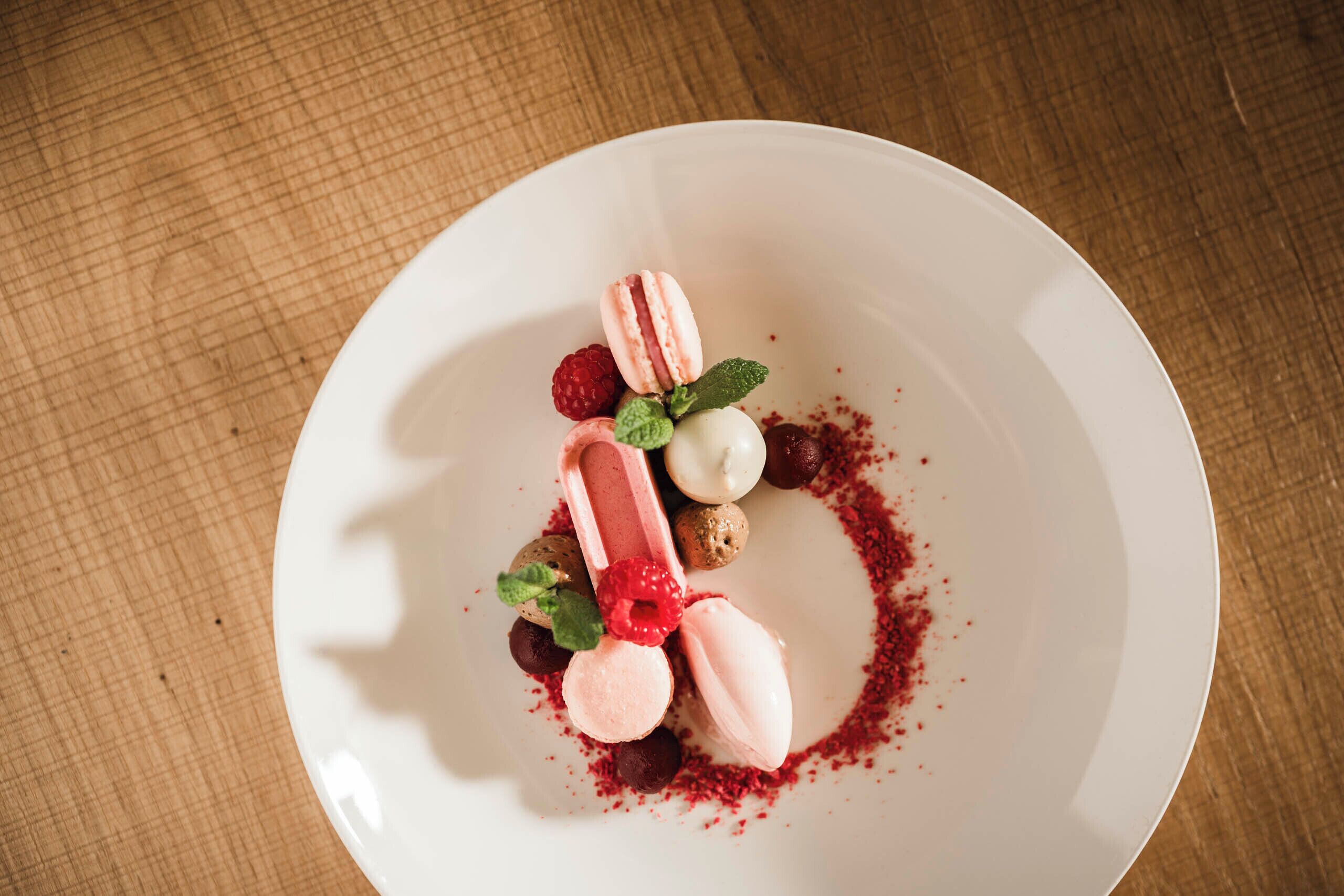 A white plate with a dessert on a wooden table.