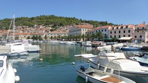 A marina with boats docked, surrounded by buildings with red-tiled roofs and a hilly backdrop. - 3 bedroom villa, sea 5 minutes walk, private parking & garden, quiet location (Ulica Bana  Mazuranica)