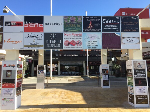 A variety of restaurant signs in a commercial area.