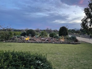 A landscaped garden with a variety of plants and a stone pathway.