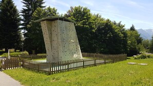A climbing wall structure with a wooden fence surrounding it. - Appt T4, 8 pers, 84m2 in chalet in calm close tracks, Ax 3 Domaines Bonascre (Ax-Les-Thermes)