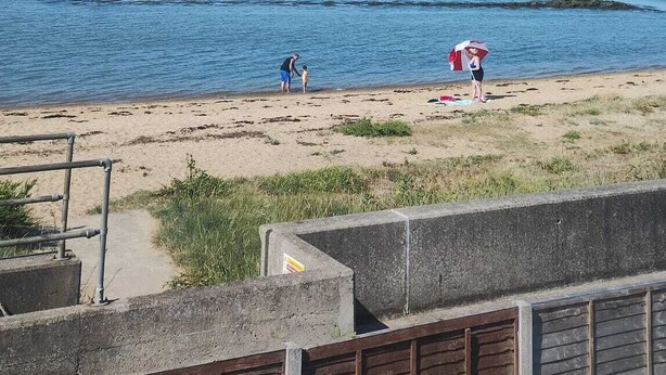 A beach with a clear sky, calm water, and a distant shoreline. - 3 bedroom holiday bungalow on the beach front, Point Clear Essex (Clacton)