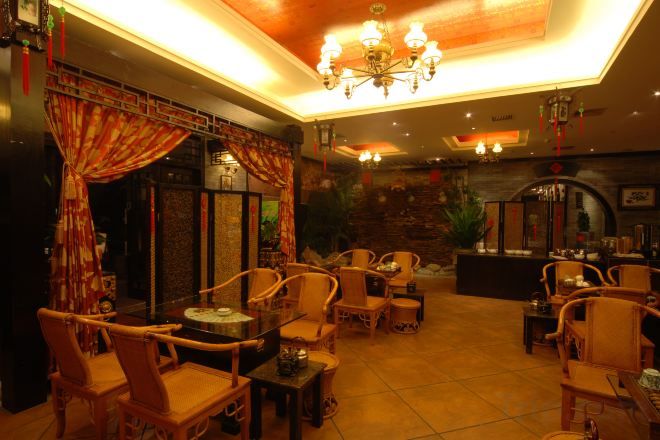 A restaurant with a traditional decor, featuring wooden furniture and a warm ambiance.