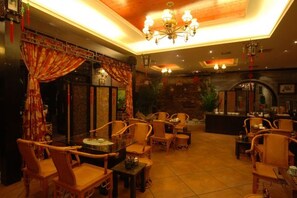 A restaurant with a traditional decor, featuring wooden furniture and a warm ambiance.