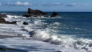 A rocky coastline with waves crashing onto the shore.