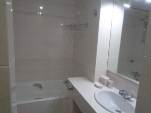 Een bad/douchecombinatie, een haardroger, een bidet, handdoeken