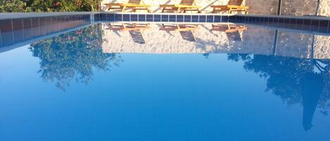 Una piscina al aire libre, una piscina climatizada